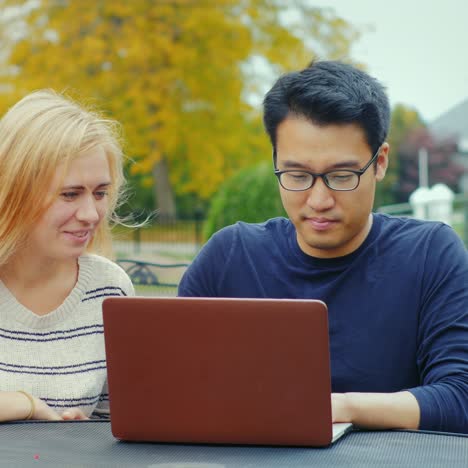 Students-Work-With-A-Laptop-At-The-Table-Of-A-Summer-Cafe-6