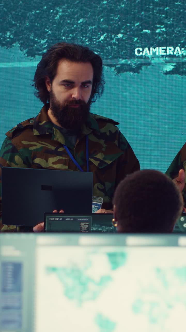 Military Soldiers Monitoring Surveillance Data in a High-Tech Control Room