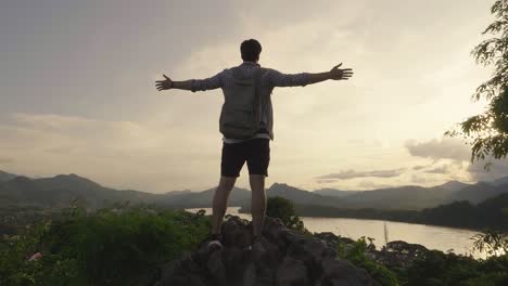 man enjoying sunset view from mountaintop