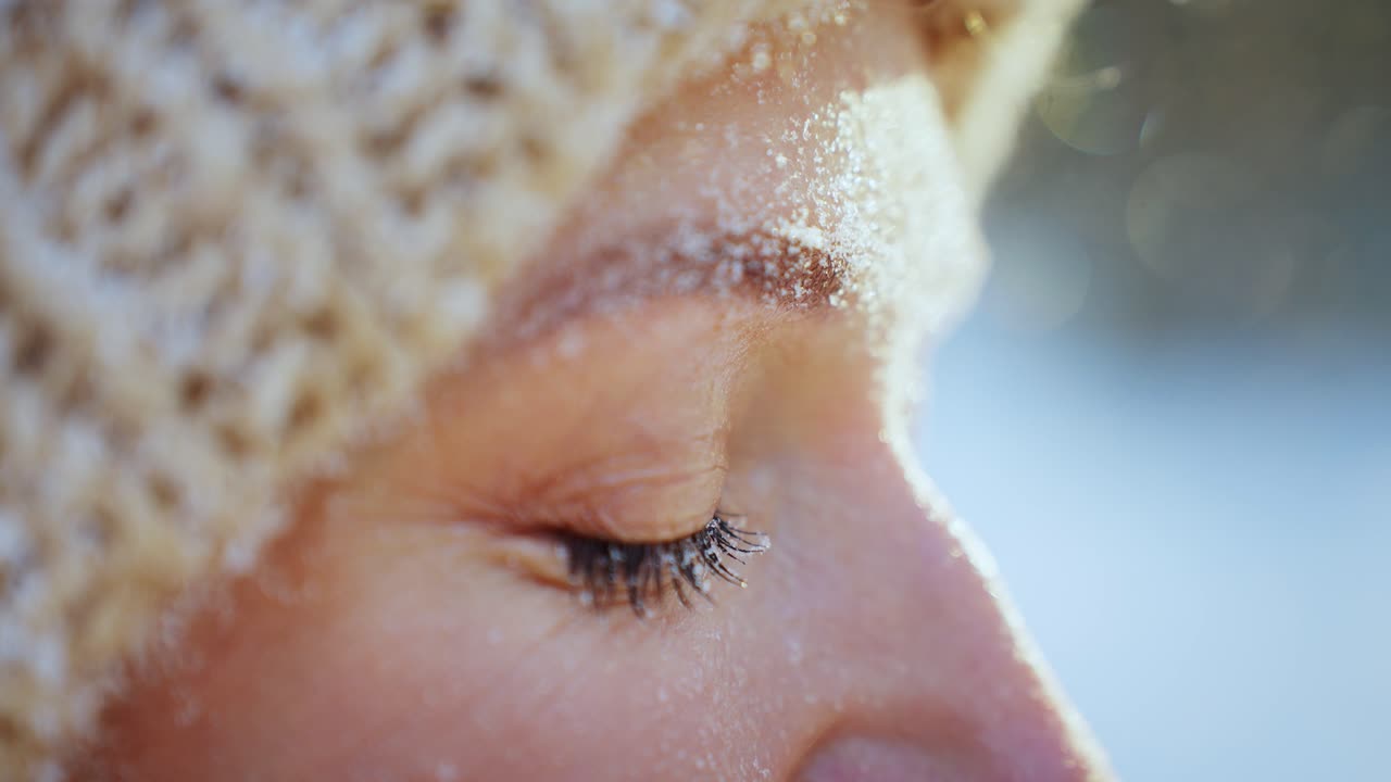Woman with snow on her face in winter