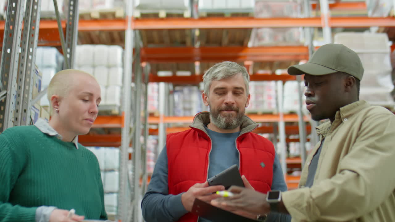 Warehouse staff discussing inventory and logistics