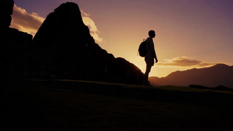 silhouette of a hiker at machu picchu sunrise