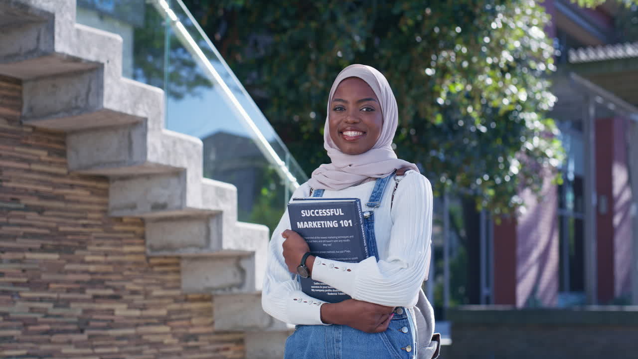 A young woman holding a book about marketing