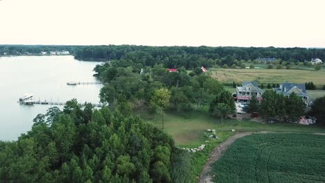 picturesque coast of kent island, coastal forest, dock and villa, aerial view