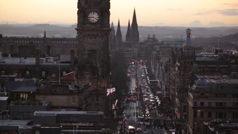 edinburgh cityscape at dusk with historic clock tower and traffic