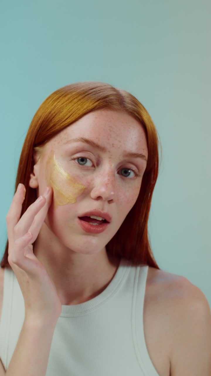 mujer aplicando una máscara de oro