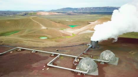 beautiful drone shot of the krafla geothermal area in iceland with pipes steaming vents and sheep warming themselves