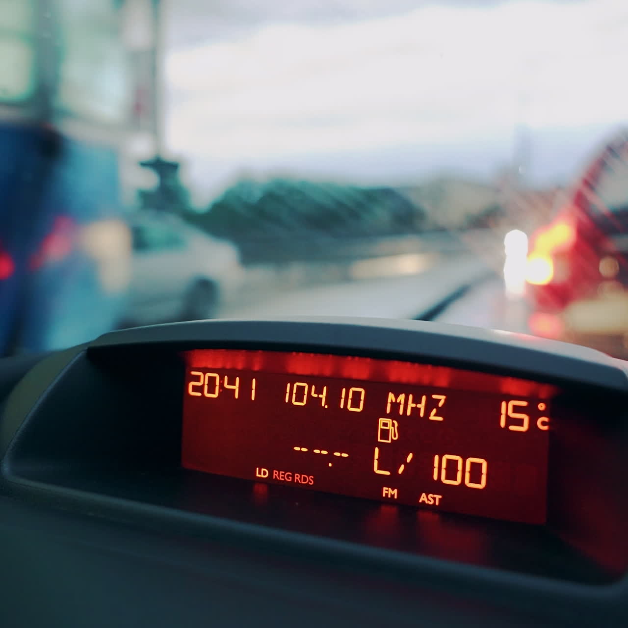 Driving a car in traffic jam in bad weather conditions. Car dashboard. Close-up