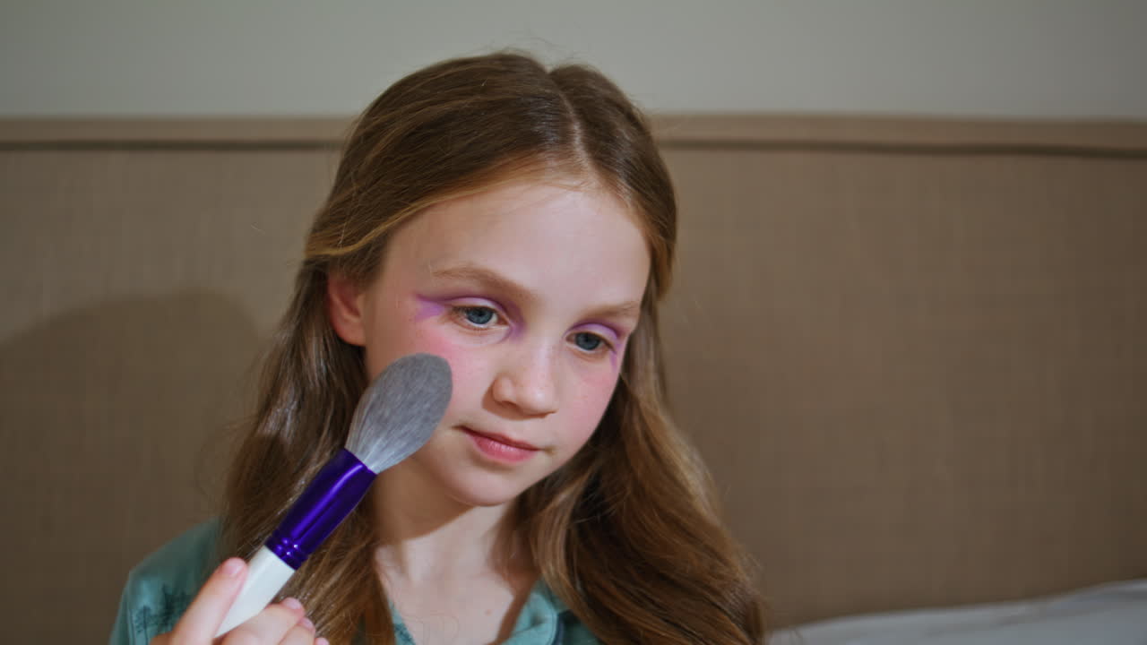 Closeup toddler girl makeup playing with mamas cosmetics pretending grownup