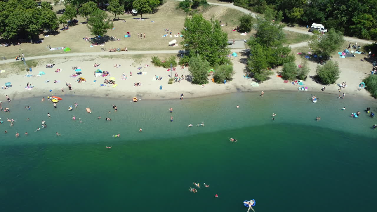 Aerial View of Lake Beach with People Relaxing and Swimming