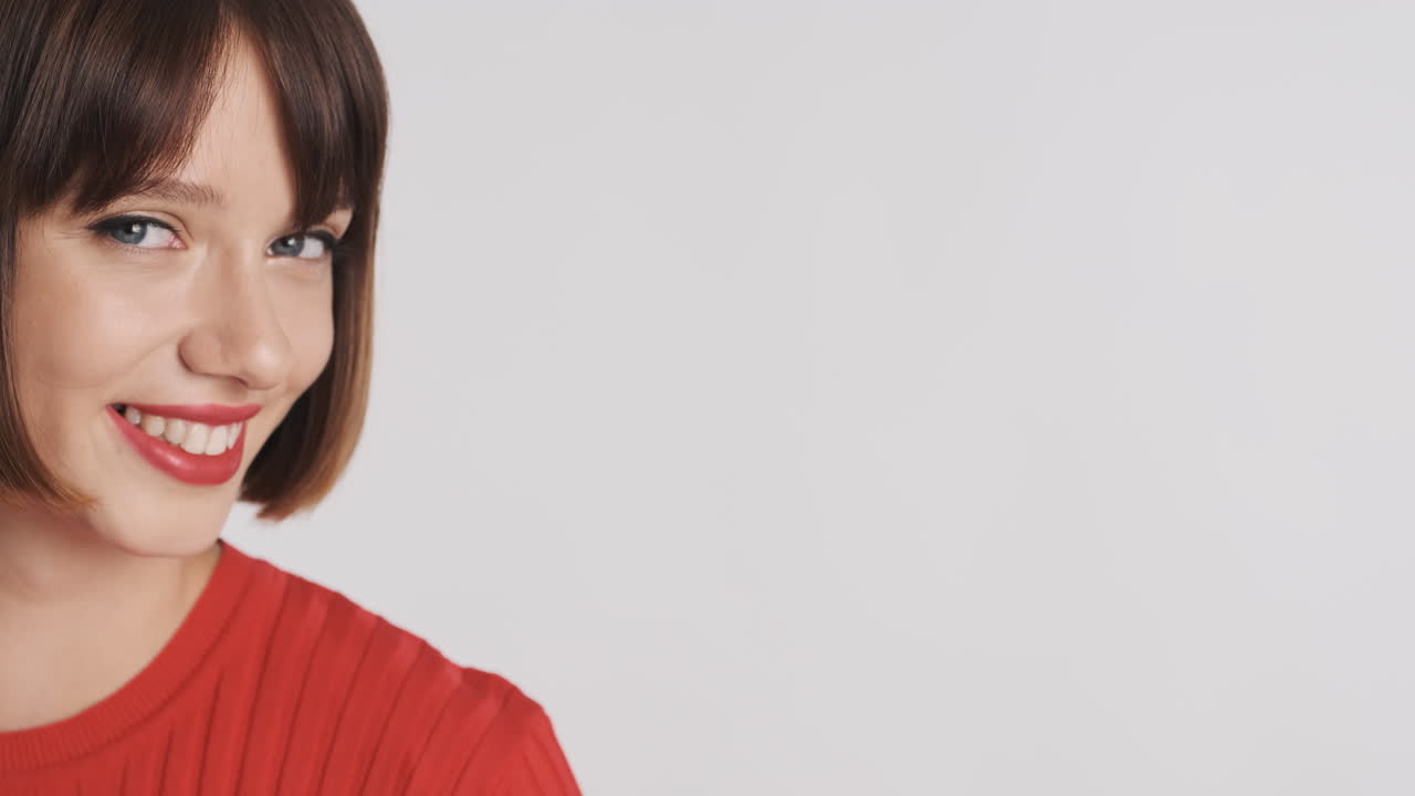 Half-portrait of woman smiling with red lips
