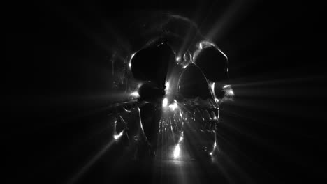 Silver-Metal-Skull-on-Black-Background,-Rotating-and-Emitting-Light-Rays