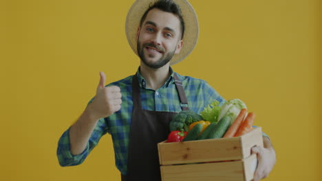 farmer holding a wooden crate full of fresh vegetables