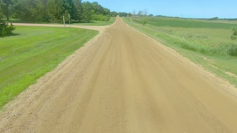 pov driving on a gravel road and turning into a rural county park