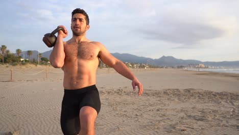 training-on-the-beach-with-kettlebell-and-shirtless-at-sunrise