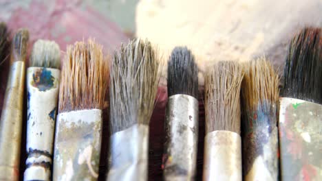 Various-paint-brushes-on-table