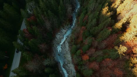 scenic mountain river waterfall canyon with fresh blue water in the idyllic bavaria austria alps, flowing down a beautiful forest along trees near sylvenstein speicher and walchensee