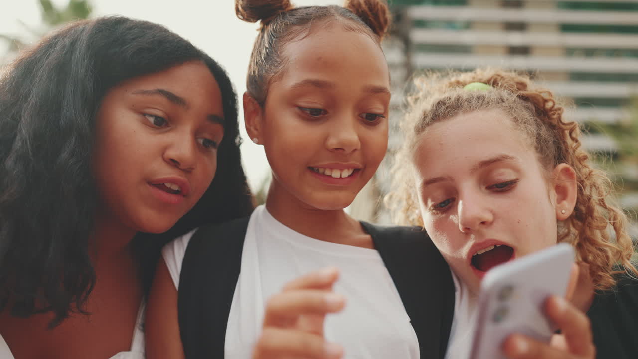 Three Teenagers Looking at a Cellphone