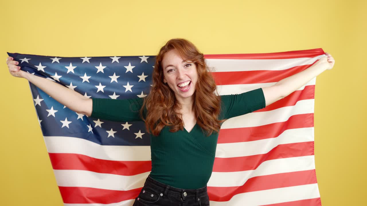 Happy woman proudly holding the American flag