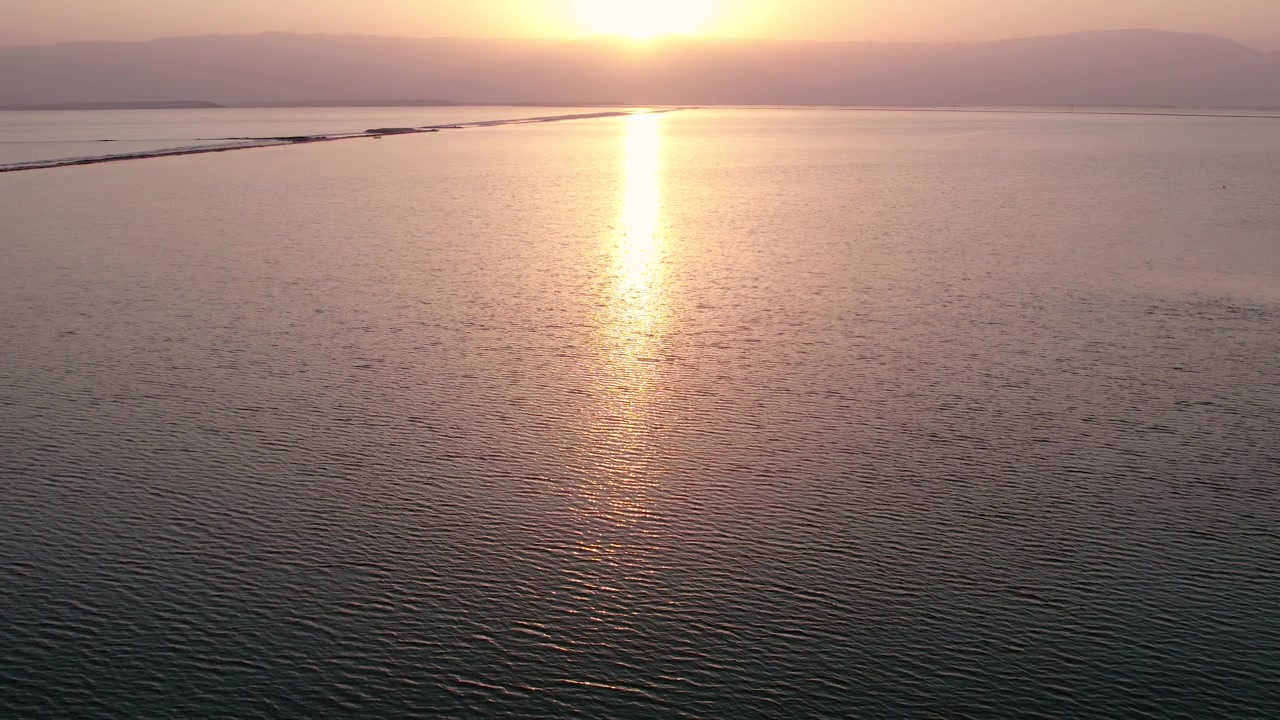 Aerial View of Serene Sea at Sunset with Golden Sun Reflection