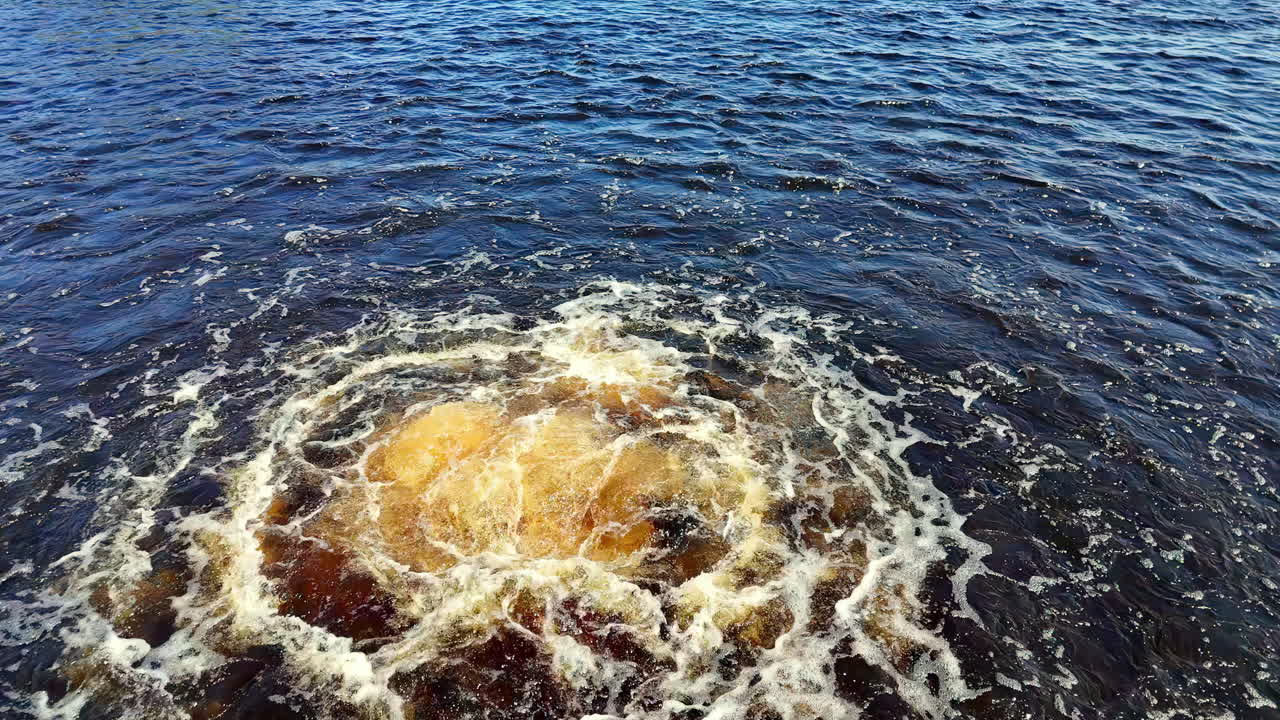 Wide-Angle Massive Underwater Gas Leak Surface Disturbance Turbulent Plume of Foaming Yellow-Brown Water Erupting from the Depths into the Dark Blue Sea, Reflecting the Nord Stream Pipeline Incident