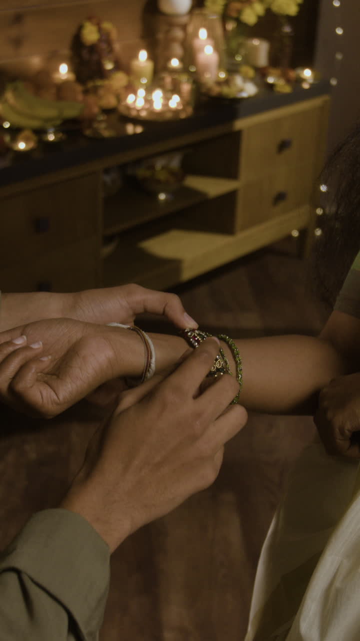 Close-up of hands putting on bracelets