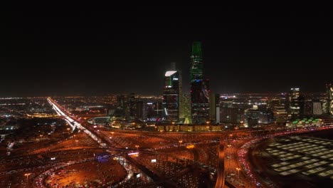 king abdullah financial center in riyadh city at night with high traffic street.
