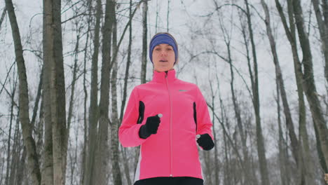 woman running at snowly winter under sunlight.