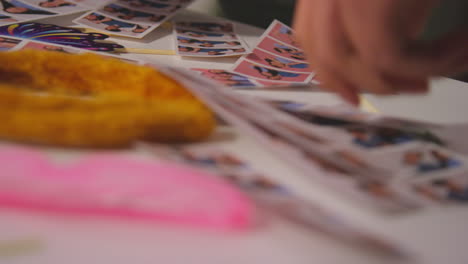 Close-Up-Of-A-Group-Of-Friends-Having-Fun-Looking-At-Prints-From-Photo-Booth-With-Props-1