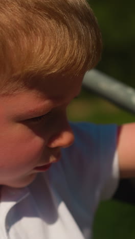 thoughtful boy in polo spends time riding cable car. little child rests enjoying spectacular view of mountains and forest. concept of relaxation in nature