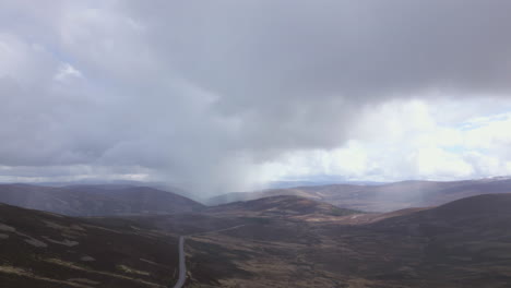 rain arriving in cairngorms, scotland. aerial descending