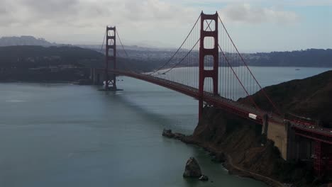 san francisco golden gate bridge aerial drone california horseshoe bay area point cavallo needles rock dana bowers vista point grey cloudy mist misty fog skies sausalito cars traffic backwards