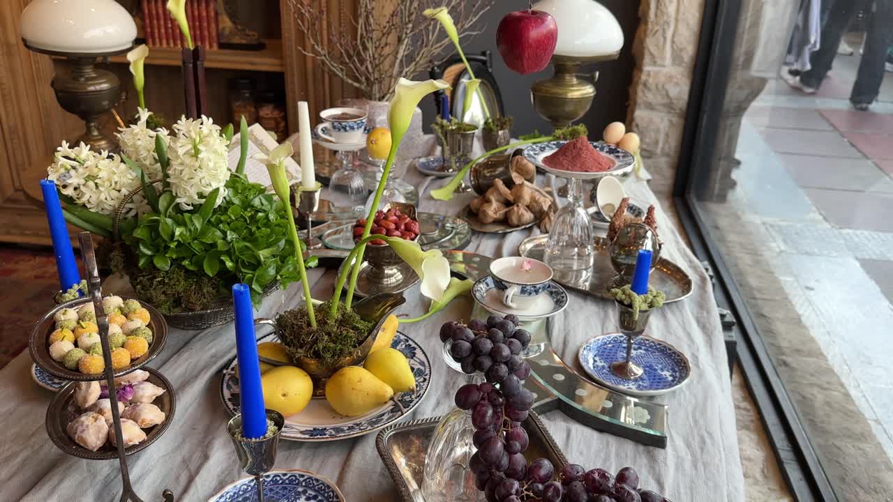Wooden street side artistic ritual table Haftsin Persian New Year Nowruz Tehran Iran family celebration fresh fruit Hyacinth nuts samanu culture colorful decoration traditional architecture interior