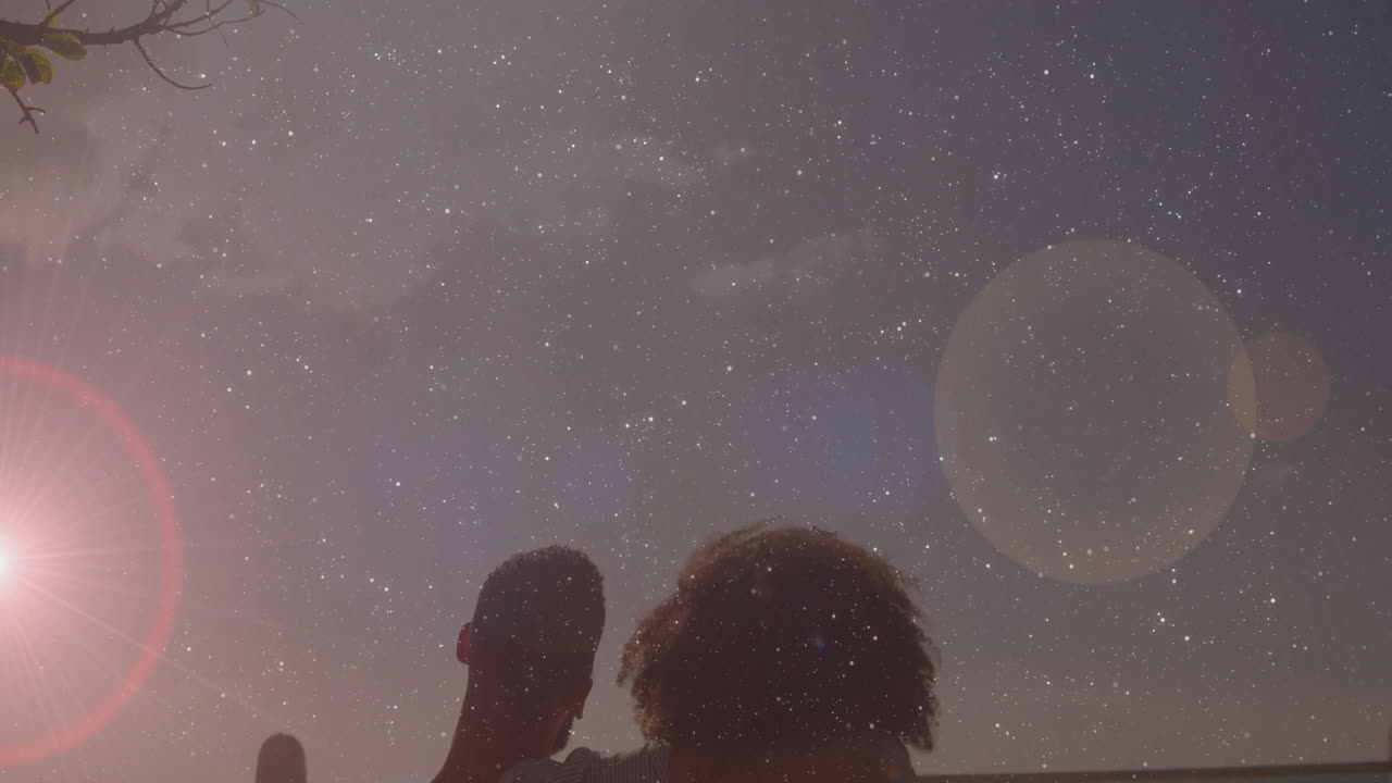 Embracing under starry sky, couple standing by ocean during sunset animation