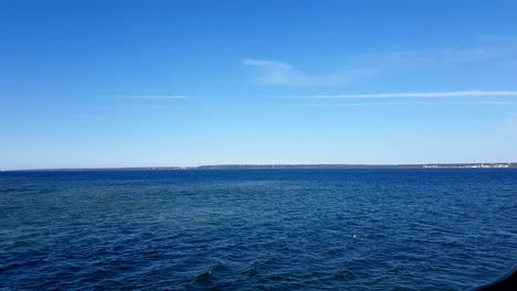 view of the ocean and clouds in the sky. blue sky with clouds in sunny weather over the ocean.