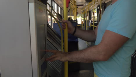 man using bus ticket machine