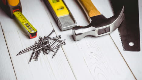 animation of diy tools and nails on white wooden boards