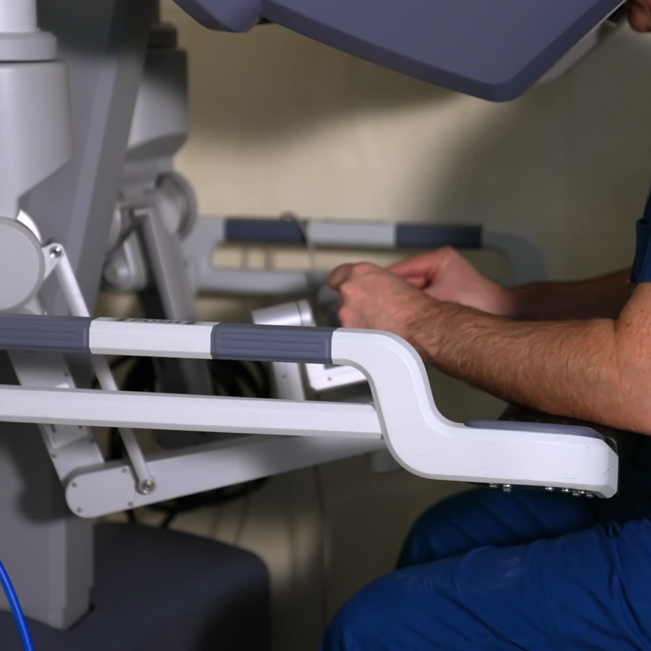 Surgeon moving slowly and carefully the manipulators of motion controller. Medical professional operating the futuristic surgeon robot. Side view