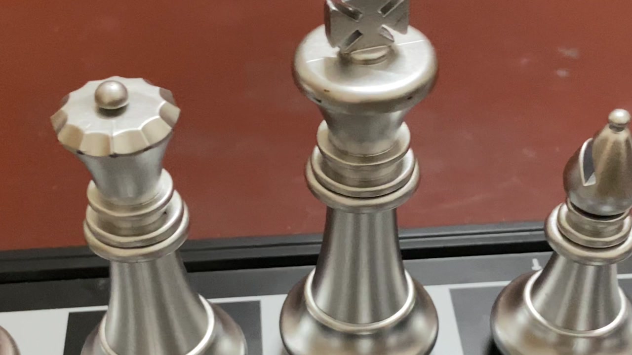 Intellectual chess game board arranged with silver pieces on chess board - close up short.