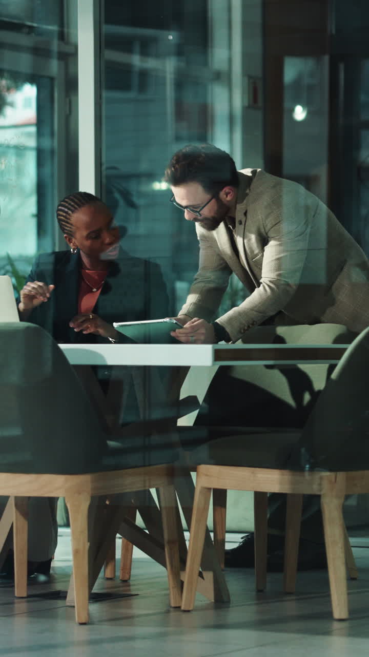 Business Professionals Discussing Project on Tablet in Modern Office