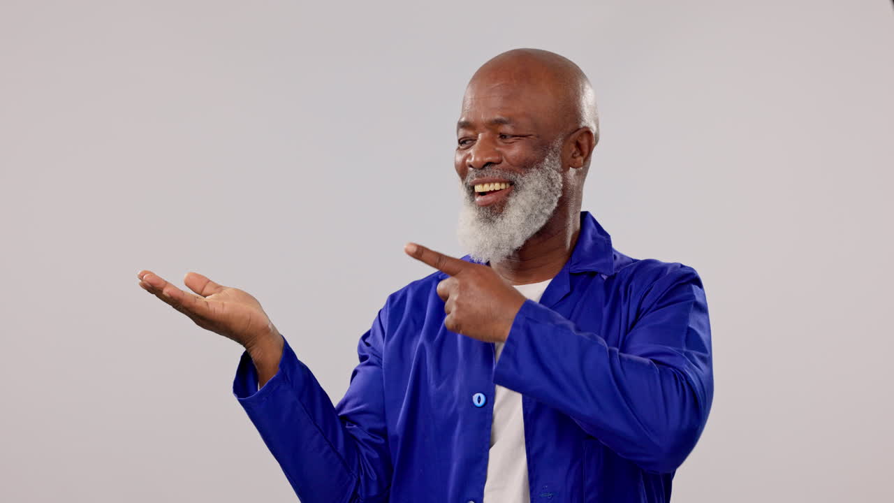 Happy, mature black man and point at palm gesture