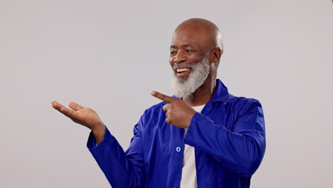 happy, mature black man and point at palm gesture