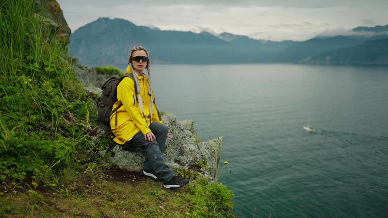 Woman Hiking on Cliff with Lake and Mountain View
