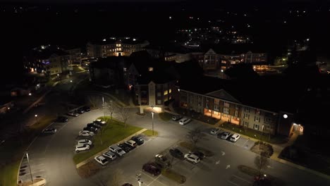 High-aerial-orbit-around-assisted-living-retirement-home-buildings-in-America-at-night