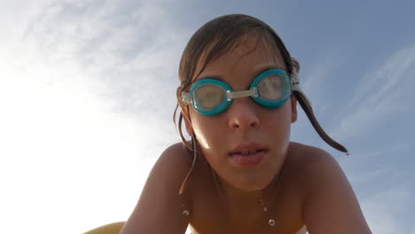 a young boy swims underwater in a pool