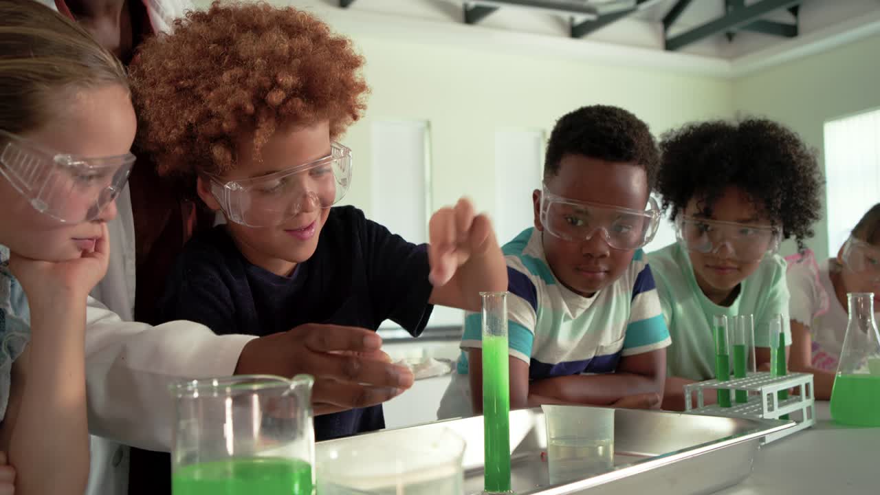 Diverse kids in lab teacher placing tablet, African-American boy adding it, showing tube reaction