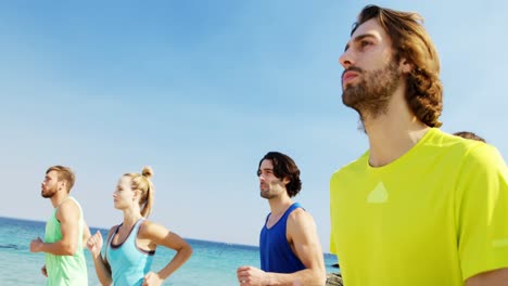 Fit-man-and-woman-jogging-at-beach