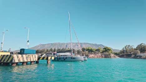 sailboat approaching a mountainous coastline