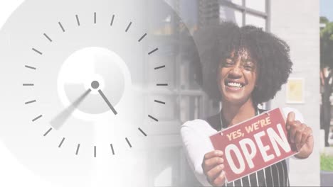 Digital-clock-ticking-against-female-african-american-waitress-holding-open-sign-outside-the-cafe