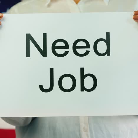 Women's-Hands-Hold-Poster-Needed-Work-Amid-American-Flag